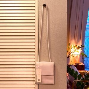 White real leather thin cross body purse.